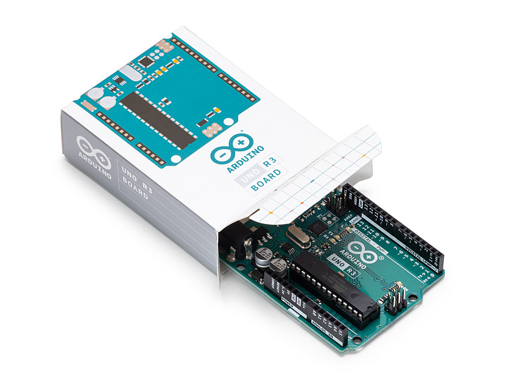 Arduino Uno Rev3 board placed next to its official packaging, showcasing the board and the branded box.
