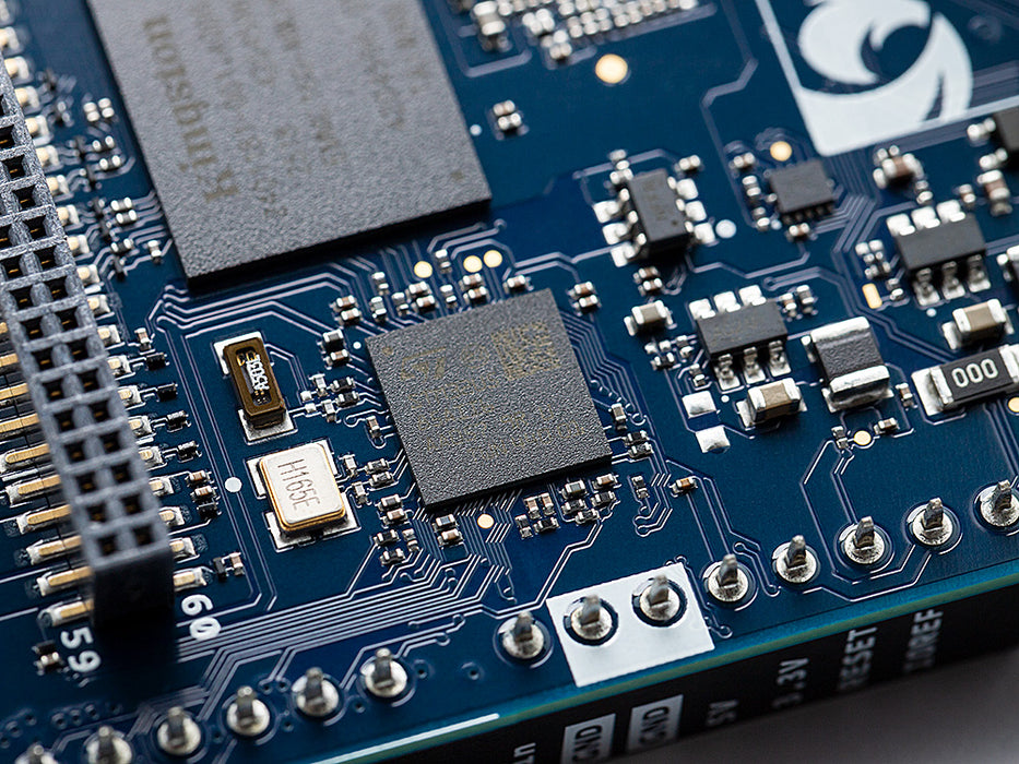 Close-up of memory chips and components on the Arduino UNO Q board.