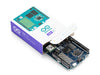 Arduino Uno Q single-board computer being pulled out of its purple and white retail packaging, showing the Qualcomm processor and electronic components on the blue PCB.