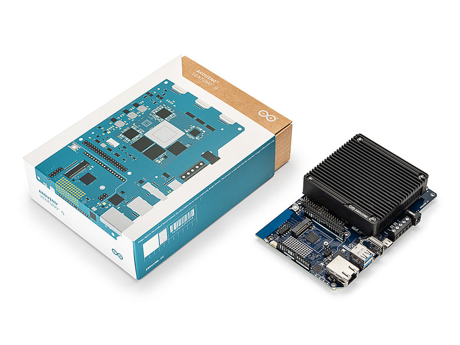 Unboxed Arduino VENTUNO Q board, showing the retail box beside the assembled board with its heatsink module, camera connector, and USB and Ethernet ports.
