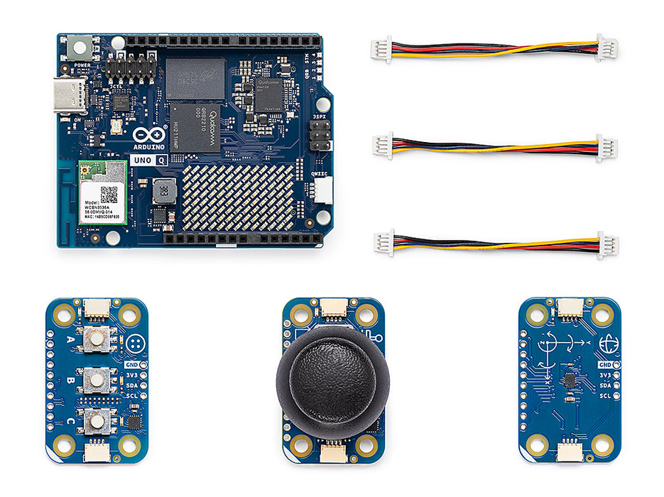 Top-down close-up view of the Arduino UNO Q microcontroller board and Modulino modules, featuring the Qualcomm Dragonwing processor, STM32 MCU, and classic Uno pin headers.
