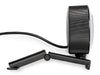 Side view of the Arduino USB Camera, showing the ribbed cylindrical housing, attached USB cable and hinged monitor clip unfolded into a flat stand.