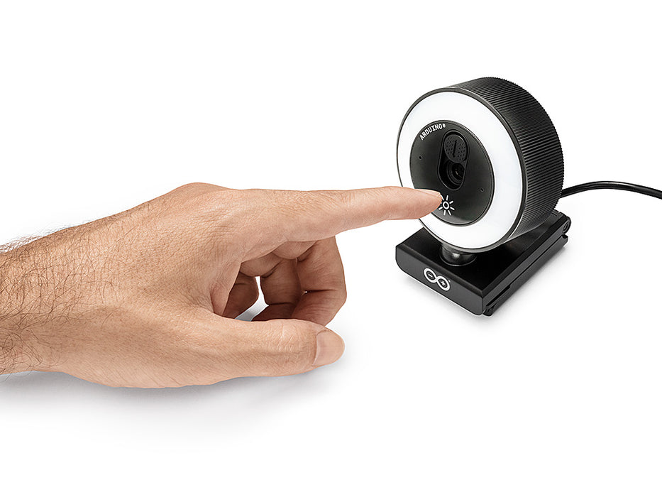 Lifestyle view of a finger touching the light icon on the Arduino USB Camera, demonstrating the touch-controlled dimming of the illuminated LED ring.