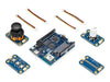 Isometric view of the Arduino UNO Q SBC controller bundle, showing the main board with a joystick, buttons, and Modulino accessory modules and cables.